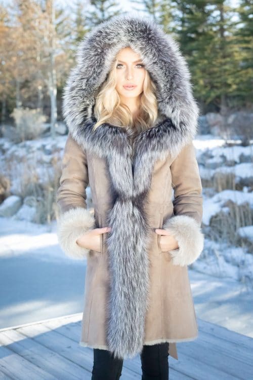 Merino Shearling with Silver Fox on a woman with her hands in her pocket outside and hood on