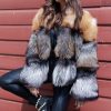 Natural Tri Colored Fox Bolero Jacket in woman standing in front of red wall