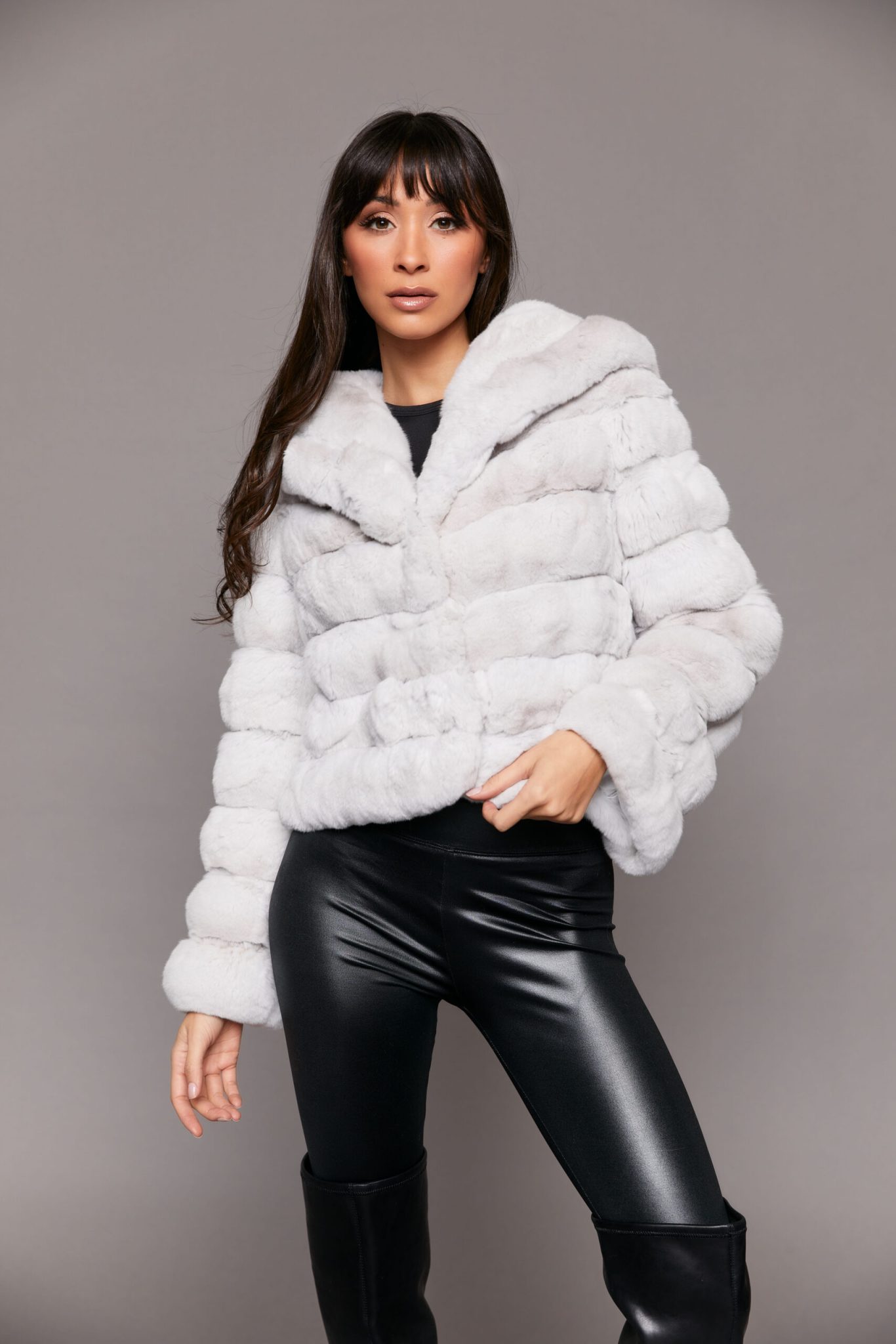 Frontal view of a woman wearing a white Erato Chinchilla Jacket with Shawl Collar standing in front of a seamless backdrop