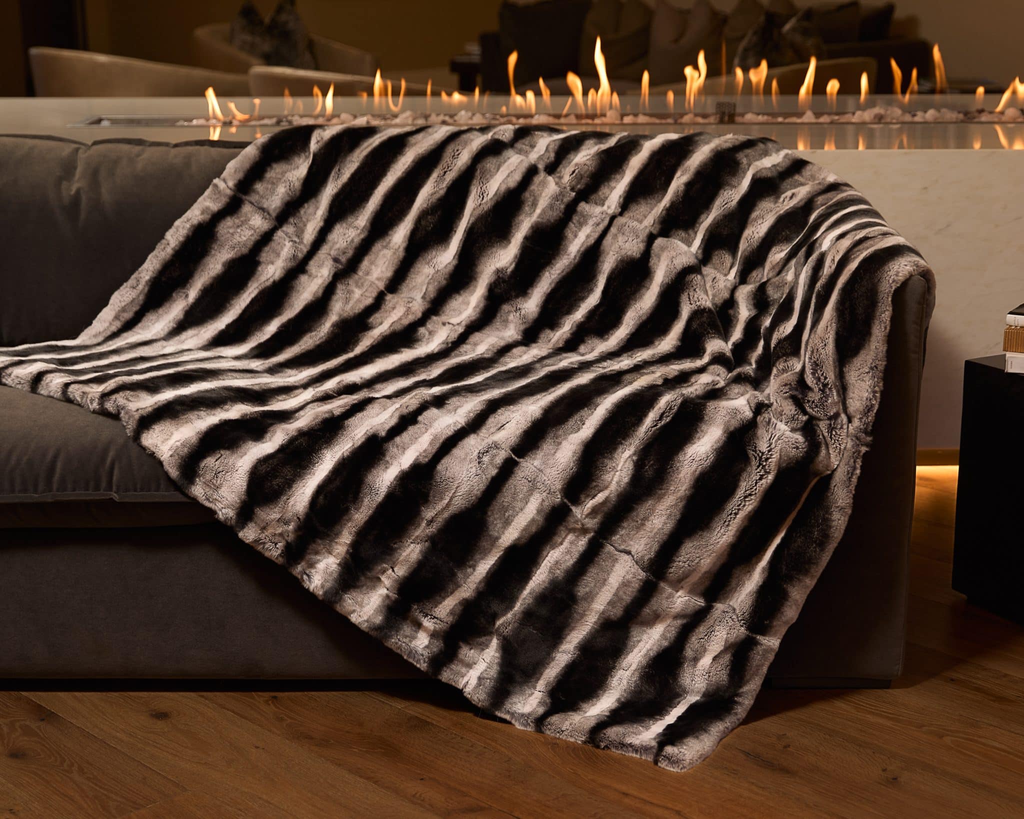 Chinchilla Rex Blanket draped over couch
