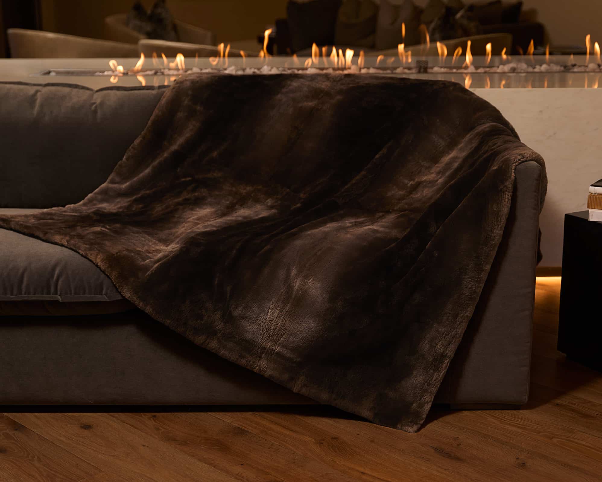 SFG BLANKETS 20243031-Recovered Phantom Beaver Blanket draped over couch