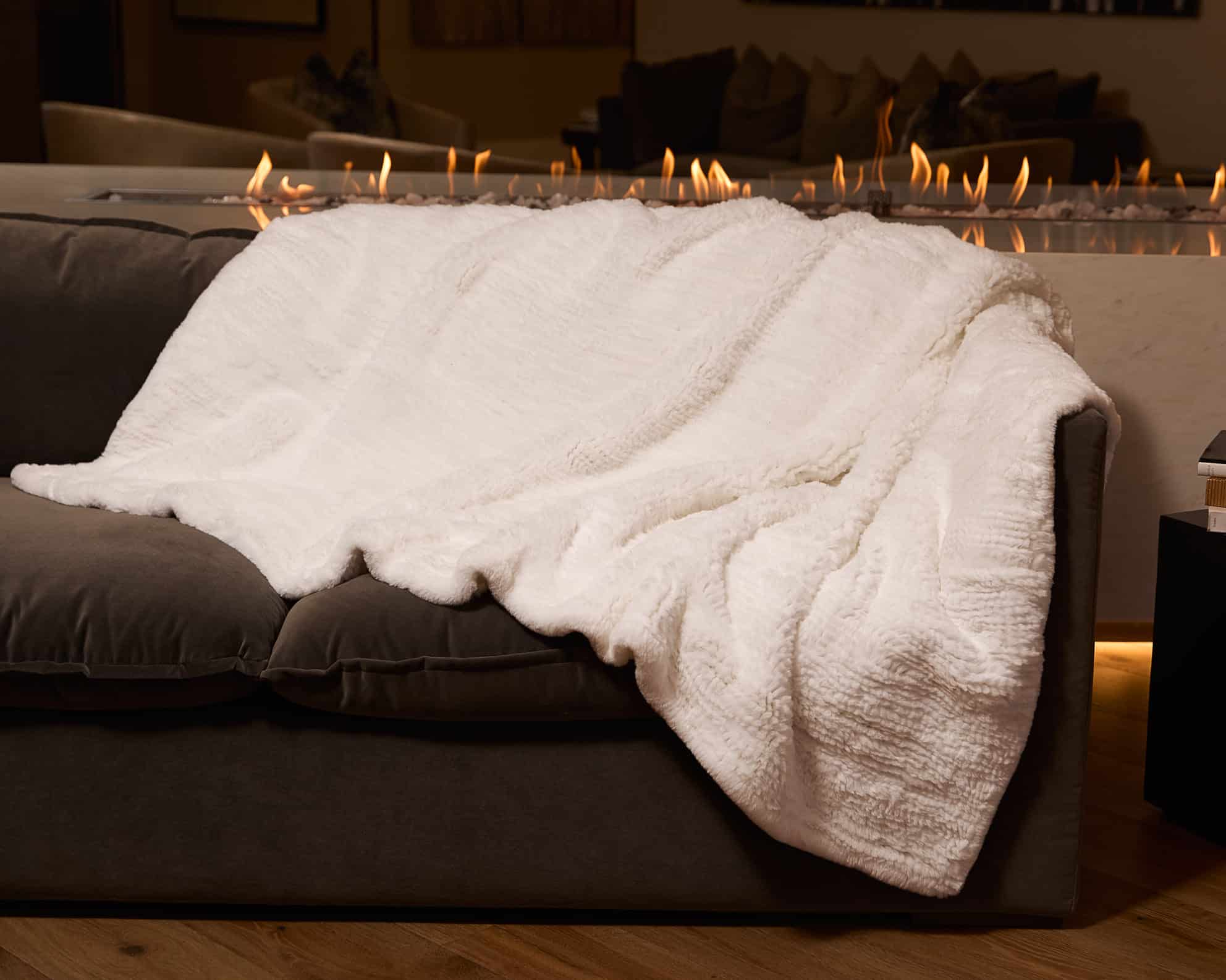 Knitted Chinchilla Rex Blanket - White - Draped over couch