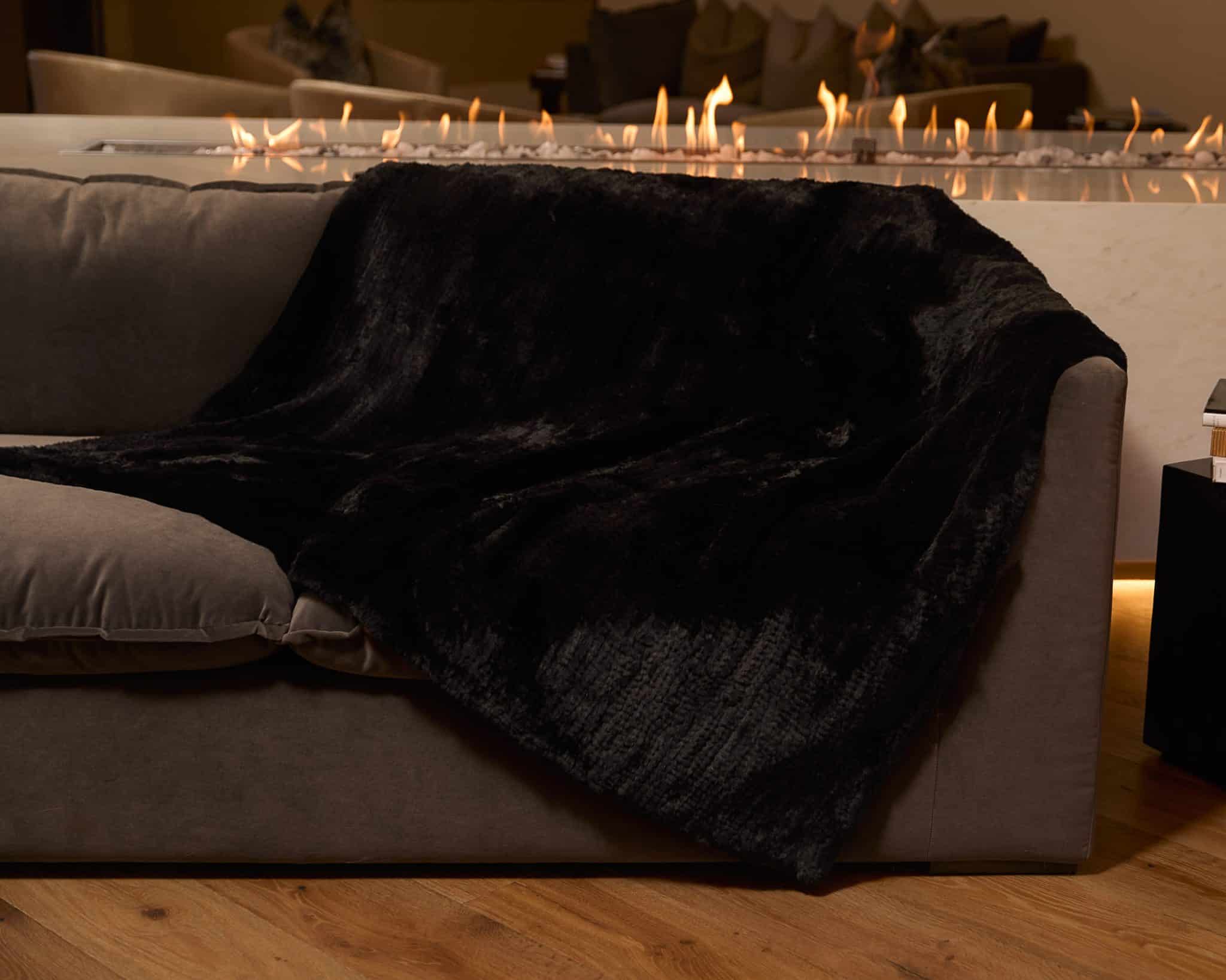 Knitted Chinchilla Rex Blanket - Black - Draped over couch