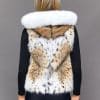SFGPHOTOPIADAY1_LOOK25_0079 Rear view of a woman in a naturally-colored lynx fur vest with the hood down standing in front of a grey background