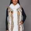 SFGPHOTOPIADAY1_LOOK37_0091 Frontal view of a woman in a lynx fur vest with fox fur trim standing in front of a grey background