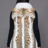 SFGPHOTOPIADAY1_LOOK37_0092 Rear view of a woman in a lynx fur vest with fox fur trim facing a grey background