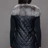 SFGPHOTOPIADAY1_LOOK40_0106 Rear view of a woman in a silver fox pelt vest facing a grey background