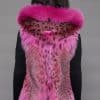 SFGPHOTOPIADAY2_LOOK1202 Rear view of a woman in a pink lynx fur vest with the hood down facing a grey background