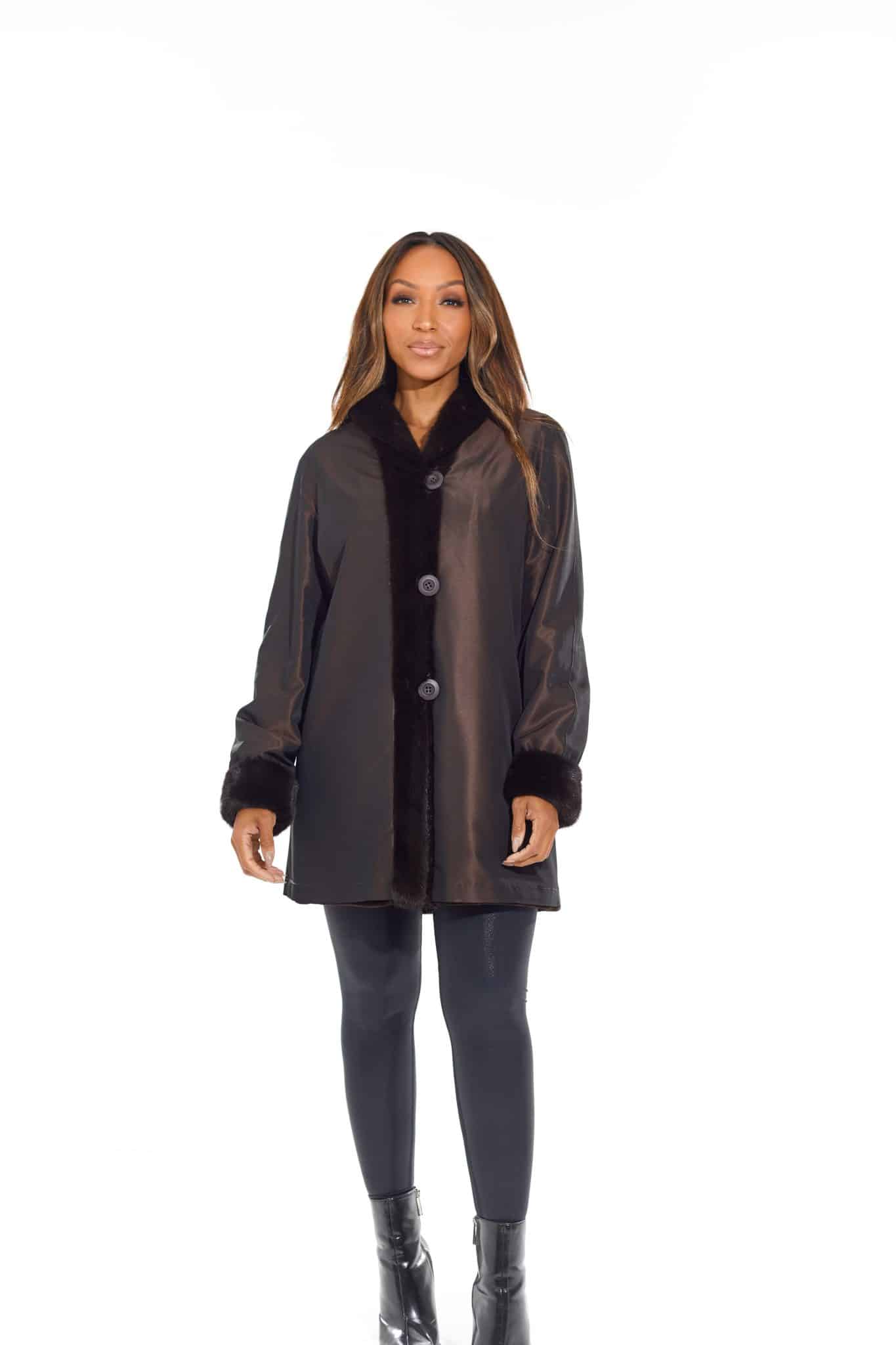 9954Espresso-2 Rear view of a woman in a black coat with the rainwear side out standing in front of a white background