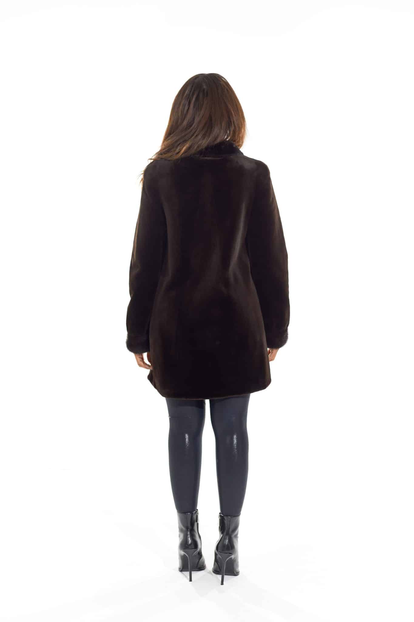 9954Espresso-3 Rear view of a woman in a black coat with the fur side out facing a white background