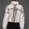 ATHANASIA CROSS MINK JACKET BACK Rear view of a woman in a white jacket against a grey background