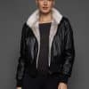 ATHANASIA CROSS MINK JACKET REV FRONT 2 woman in a black leather jacket against a grey background