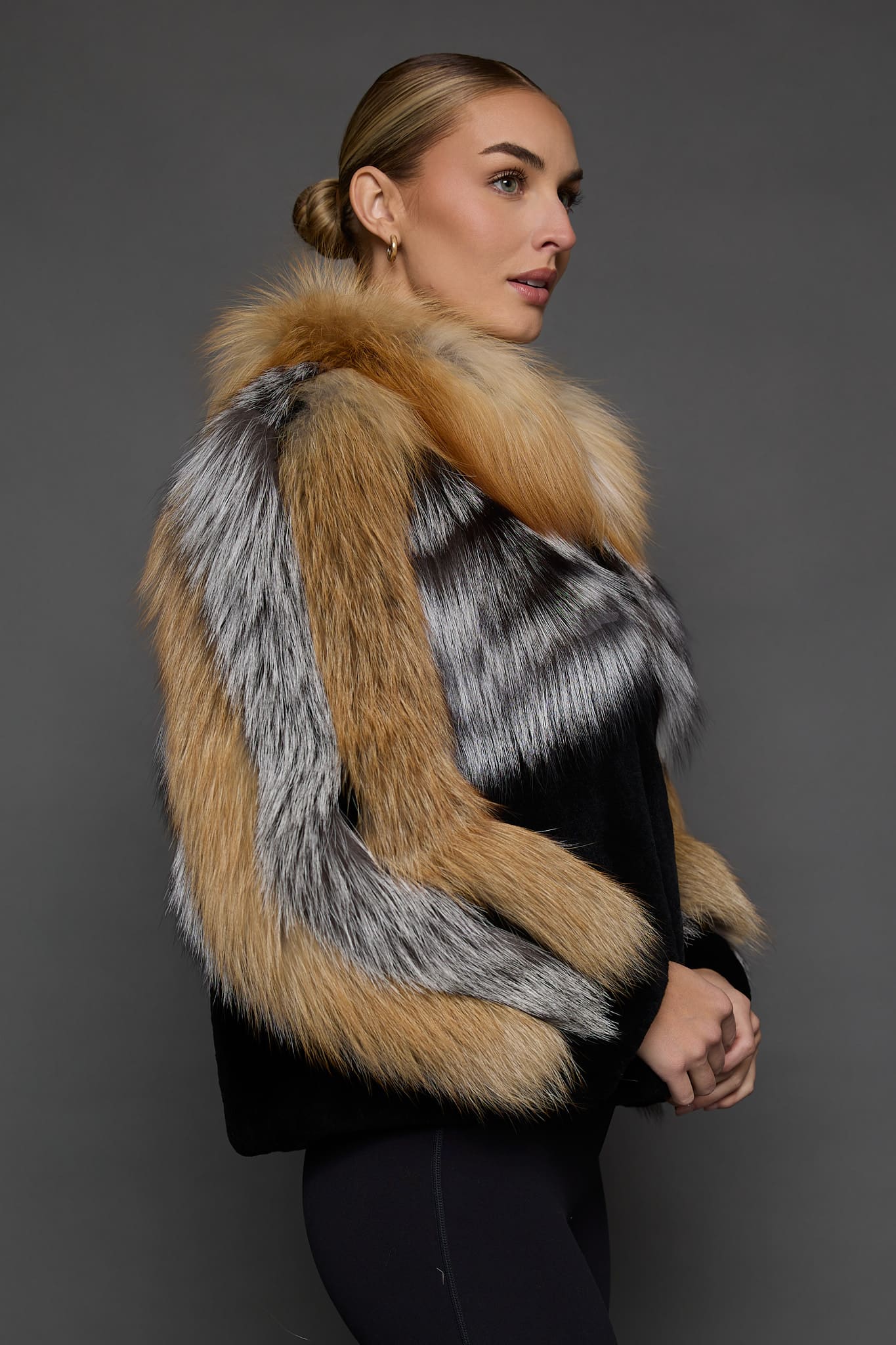 CAMILLA RED FOX JACKET SIDE side of a woman in a red and black jacket against a grey background