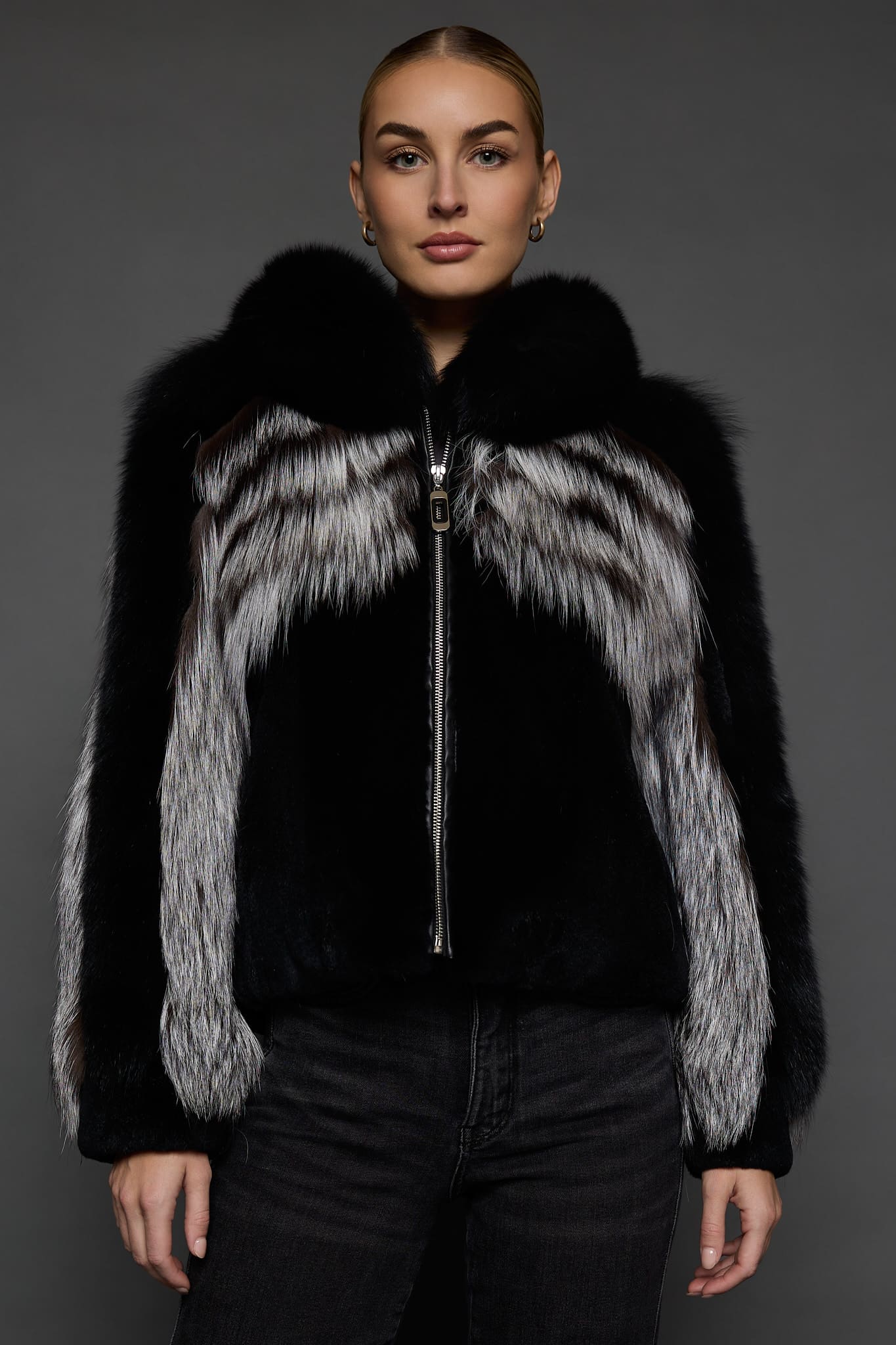 CAMILLA SILVER FOX JACKET FRONT woman in a silver and black jacket against a grey background