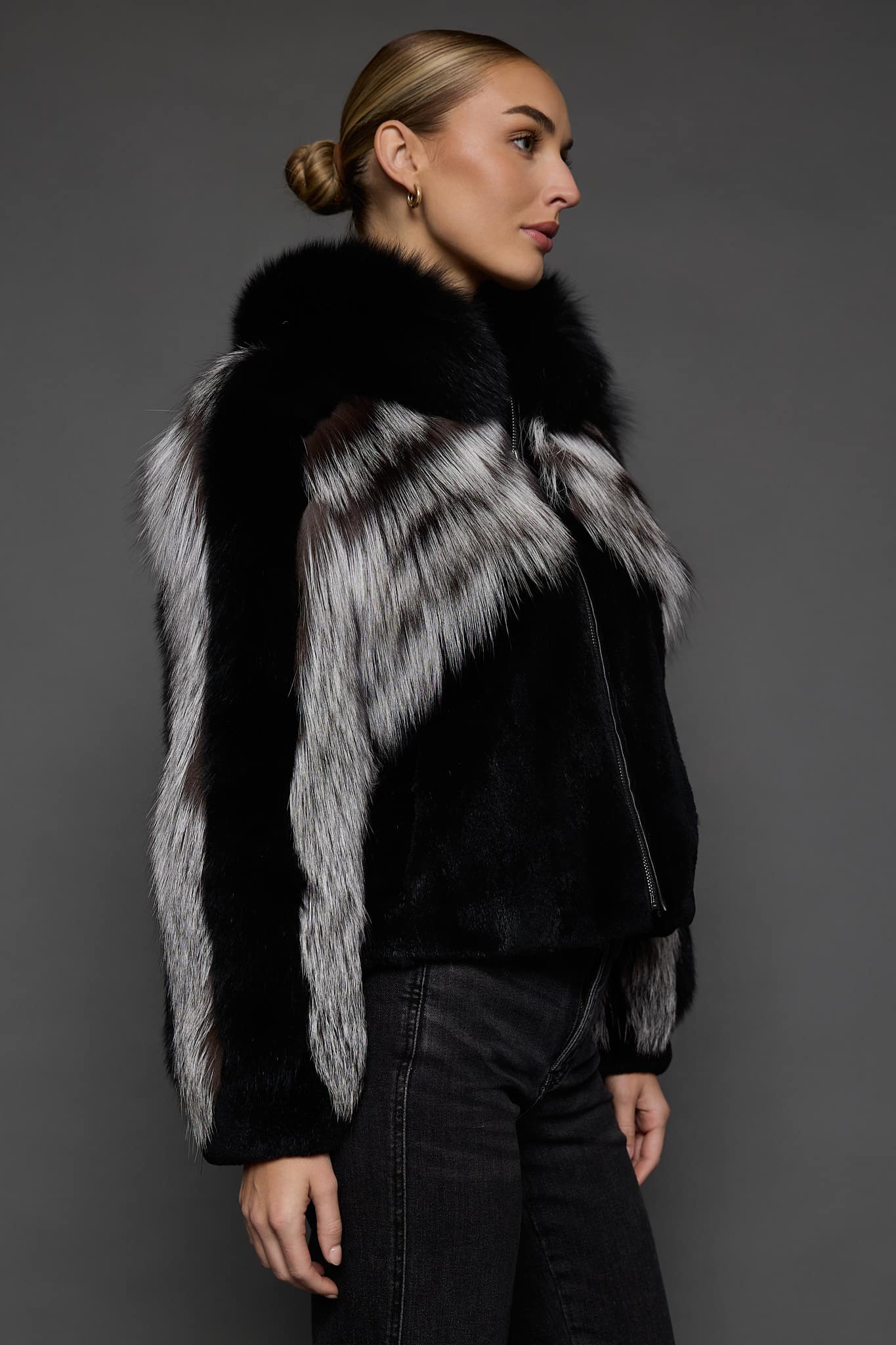 CAMILLA SILVER FOX JACKET SIDE the side woman in a silver and black jacket against a grey background