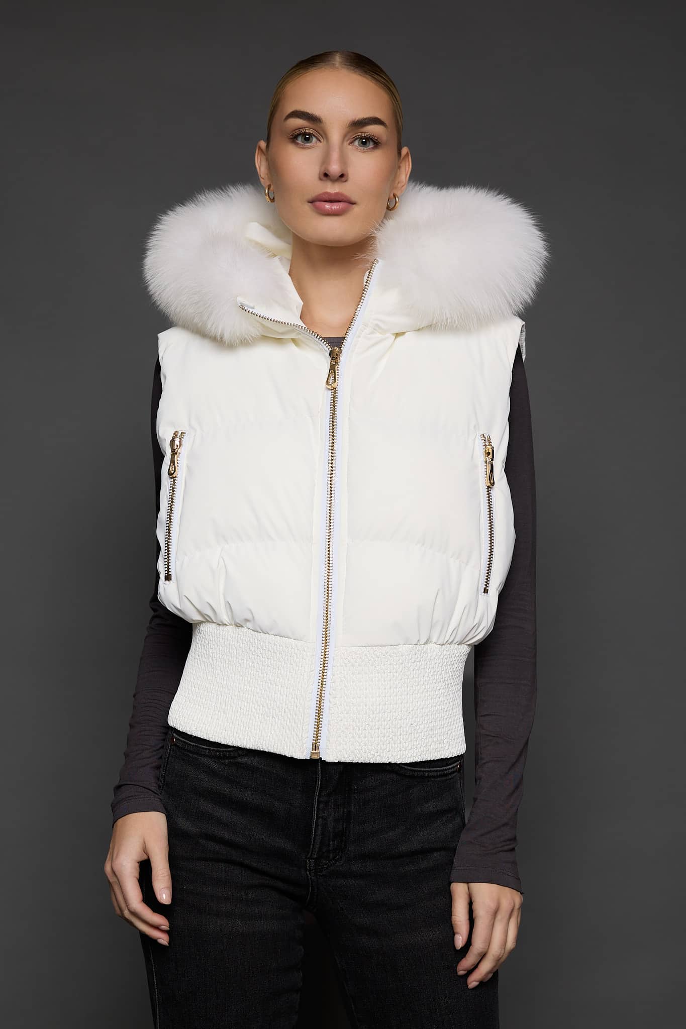 woman in a white vest against a grey background