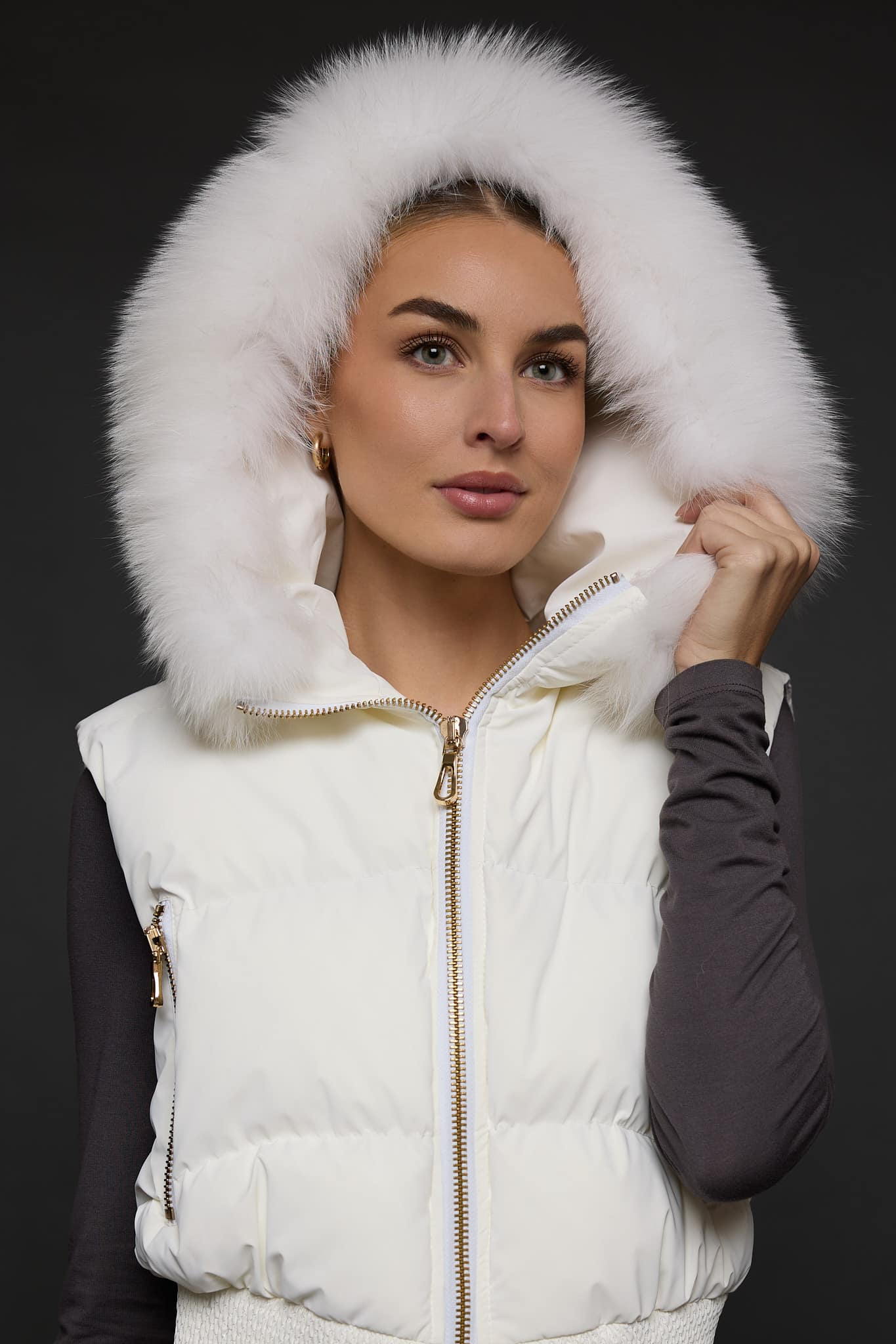 woman in a white vest against a grey background