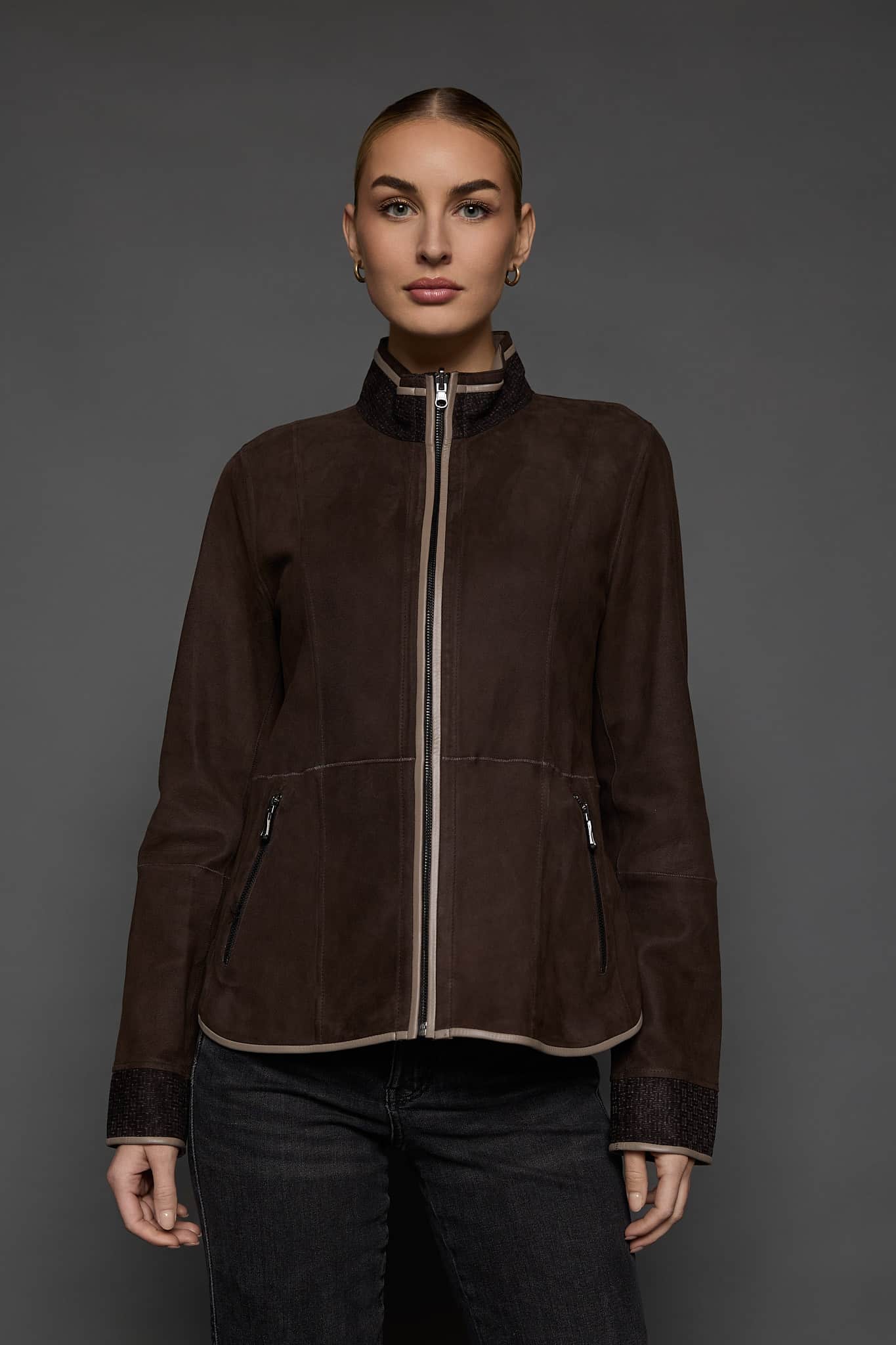 IMANI BROWN TAN JACKET FRONT woman in a dark brown jacket against a grey background