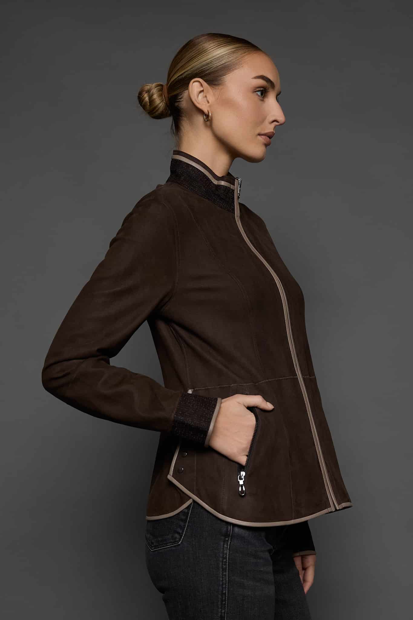 IMANI BROWN TAN JACKET SIDE the side of a woman in a dark brown jacket against a grey background