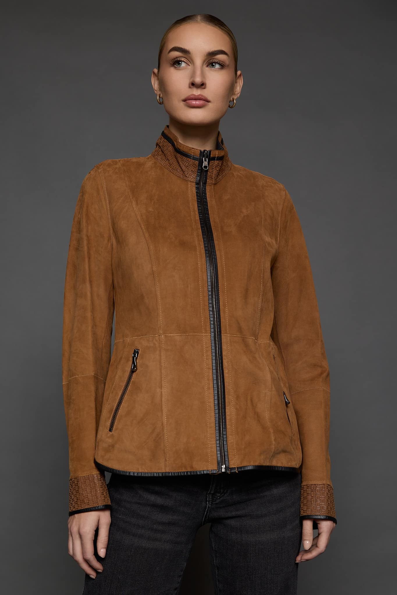 IMANI SNUFF BLACK JACKET FRONT woman in a tan jacket against a grey background