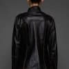 IMANI SNUFF BLACK JACKET REV BACK the back of a woman in a black jacket against a grey background