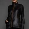 IMANI SNUFF BLACK JACKET REV FRONT woman in a black jacket against a grey background