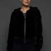 woman in a black jacket against a white background