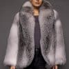 woman in a white grey fur coat against a grey background
