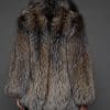 the back of a woman in a brown fur coat against a grey background