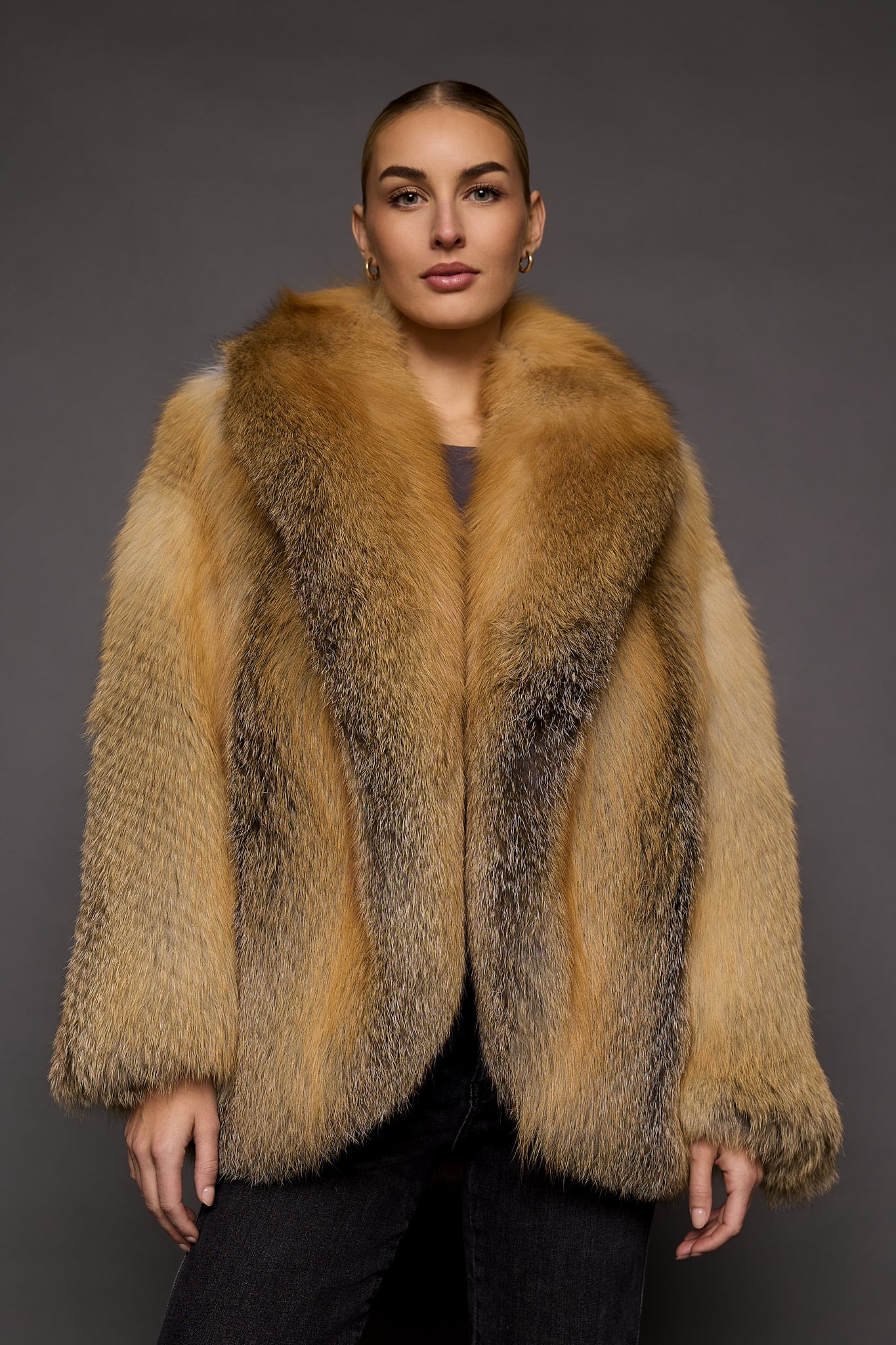 a woman in a red fur coat against a grey background