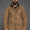 man in a tan coat against a grey background