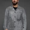 man in a grey jacket against a grey background