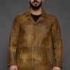 man in a brown jacket against a grey background