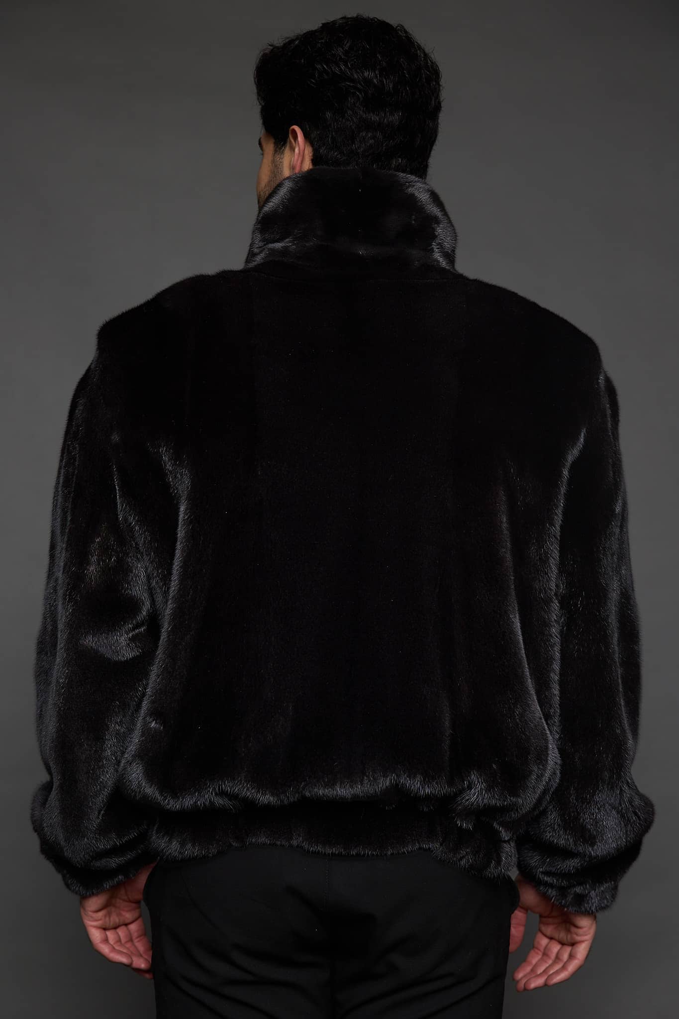 MENS JULIAN MINK JACKET BLACK BACK the back of a man in a black jacket against a grey background