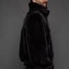 MENS JULIAN MINK JACKET BLACK SIDE the side of a man in a black jacket against a grey background