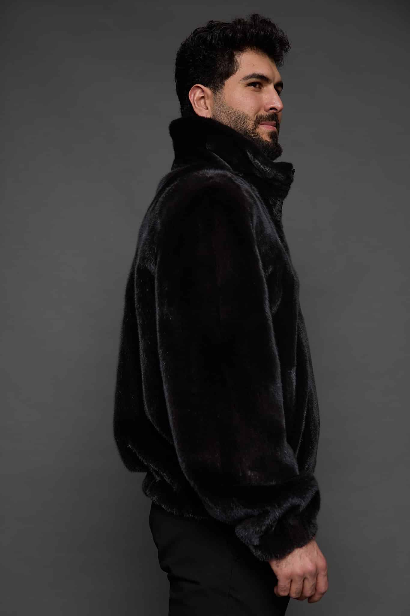 MENS JULIAN MINK JACKET BLACK SIDE the side of a man in a black jacket against a grey background