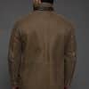 the back of a man in tan jacket against a grey background