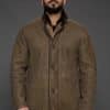 Man in tan jacket against a grey background
