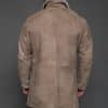 the back of a man in a tan coat against a grey background