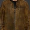 close up of a man in a brown jacket against a grey background