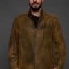 man in a brown jacket against a grey background