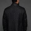 the back of a man in a black coat against a grey background