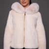 the front of a woman in a white fur jacket against a grey background