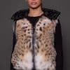 ANDI LYNX PUFFER VEST BLACK FRONT front image of a woman in a black and brown fur vest against a grey background