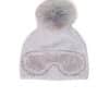 A grey beanie with ski goggles and a fox pom pom sitting atop a white background.