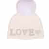 Beanie White Love A white beanie with the word "love" embroidered on it and a fox fur pom pom on it atop a white background.