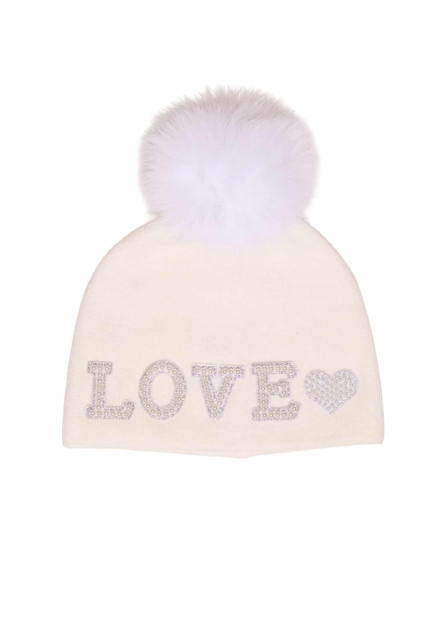 Beanie White Love A white beanie with the word "love" embroidered on it and a fox fur pom pom on it atop a white background.