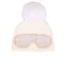 A white beanie with ski goggles and a fox pom pom sitting atop a white background.