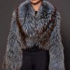 the front of a woman in a blue and grey fur jacket against a grey background