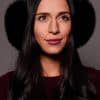 woman wearing black earmuffs against a grey background